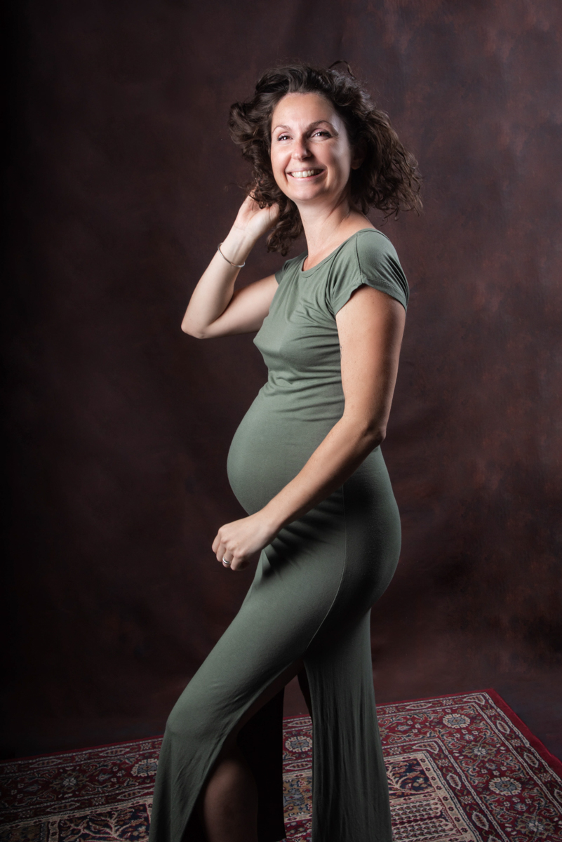 une future maman pose devant lors de sa seance maternite en studio