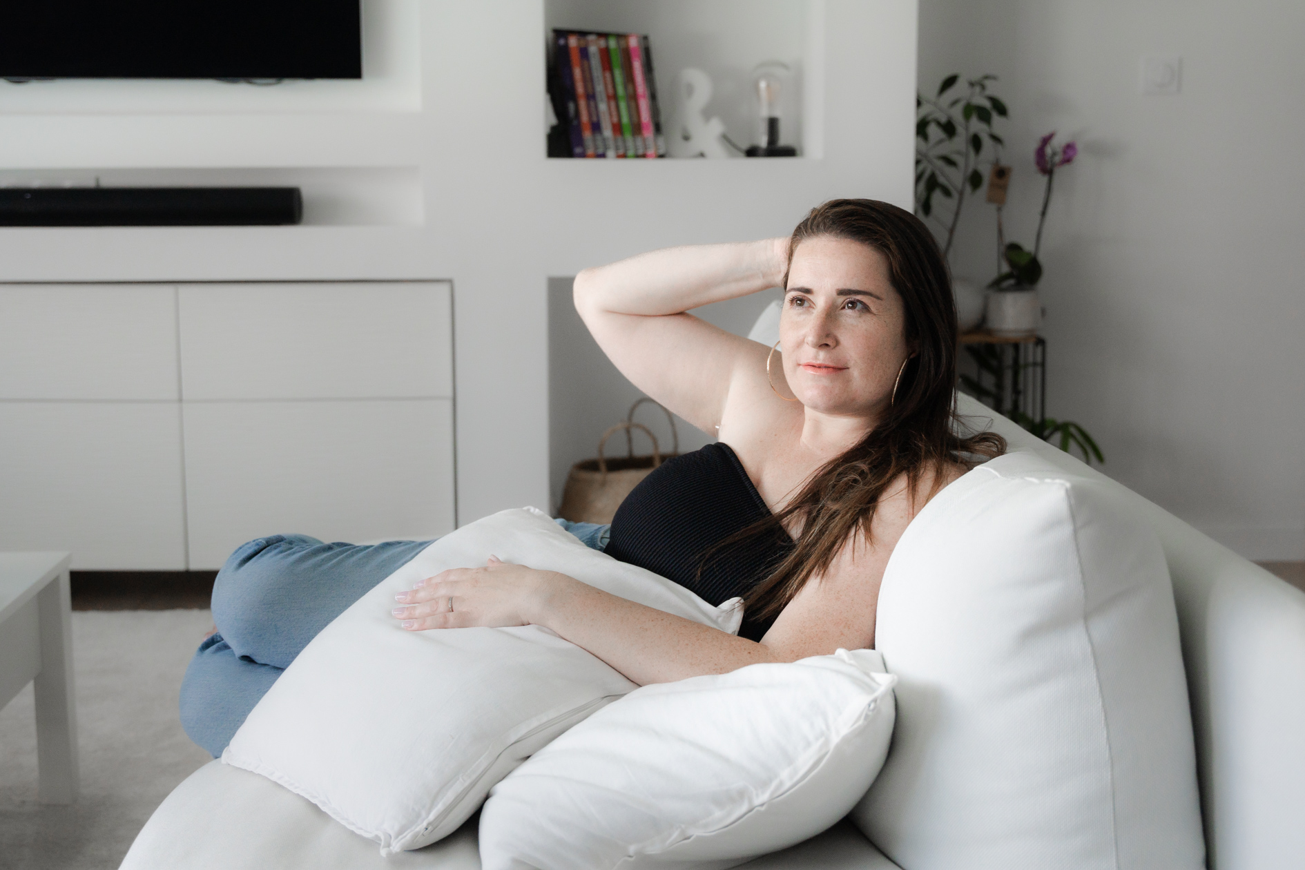 portrait d'une femme qui a le cancer du sein qui pose dans son salon lors d'une séance photo à domicile.